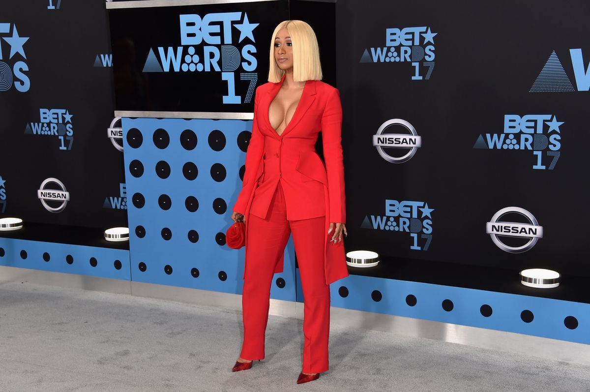 Cardi B in a Givenchy suit, Jimmy Choo clutch, and Christian Louboutin pumps at the 2017 BET Awards.