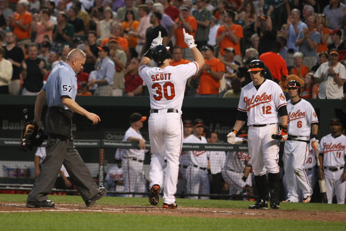 BALTIMORE, MD - JUNE 07: Luke Scott #30 of the Baltimore Orioles celebrates his fifth inning home run against the Oakland Athletics at Oriole Park at Camden Yards on June 7, 2011 in Baltimore, Maryland.  (Photo by Rob Carr/Getty Images)