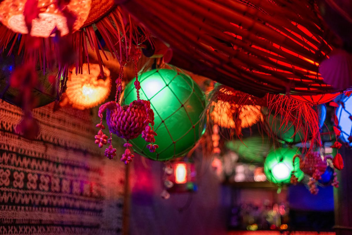 A deep red, dark close up shot of bulb lights in different colors at underground bar Tiki Mirage in Los Angeles.