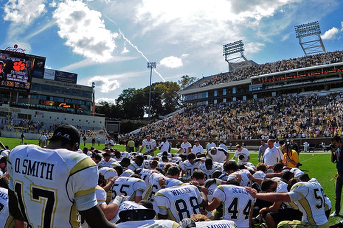 ATLANTA, GA - OCTOBER 8: Members of the Georgia Tech Yellow Jackets huddle to pray after the game against the Maryland Terrapins at Bobby Dodd Stadium on October 8, 2011 in Atlanta, Georgia. Photo by Scott Cunningham/Getty Images)