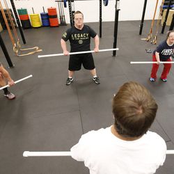 James Fitzgerald, center, and his brother, Evan, left, teach a class at Gold's Gym in Ogden on Monday, Dec. 5, 2016. James Fitzgerald, who has Down syndrome, teaches a fitness class with his brother, Evan, specifically for people with disabilities.
