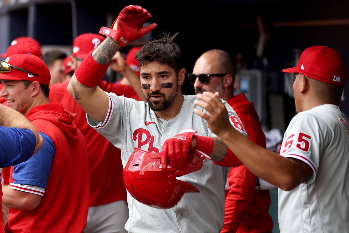 Nick Castellanos of the Philadelphia Phillies celebrates with teammates after scoring against the Atlanta Braves during the third inning in game one of the National League Division Series at Truist Park on October 11, 2022 in Atlanta, Georgia.