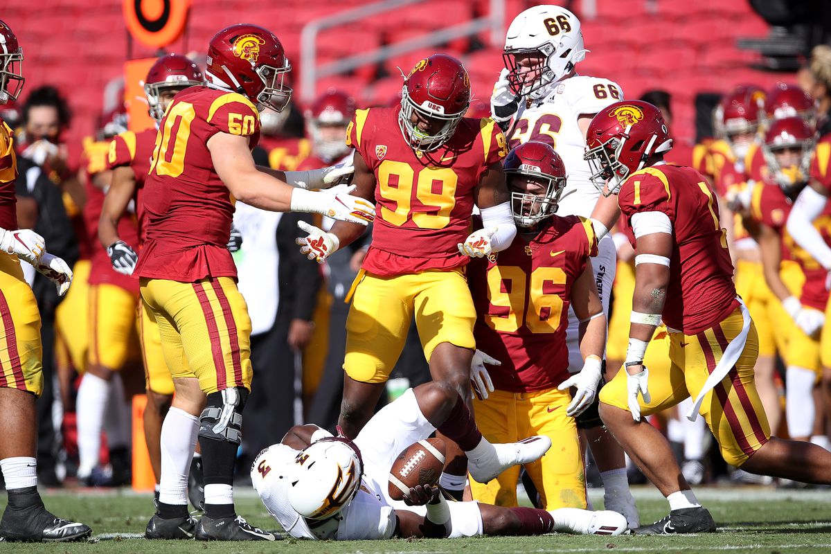 Drake Jackson, Caleb Tremblay, Nick Figueroa and Palaie Gaoteote IV #1 of the USC Trojans taunt Rachaad White of the Arizona State Sun Devils after a tackle during the first half of a game at Los Angeles Coliseum on November 07, 2020 in Los Angeles, California.
