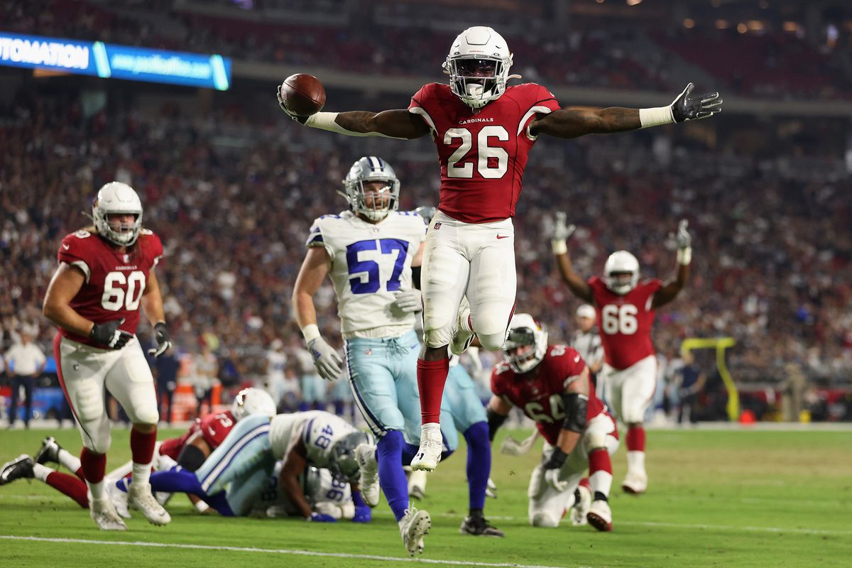 Running back Eno Benjamin #26 of the Arizona Cardinals scores on a six-yard rushing touchdown past linebacker Luke Gifford #57 of the Dallas Cowboys during the first half of the NFL preseason game at State Farm Stadium on August 13, 2021 in Glendale, Arizona.