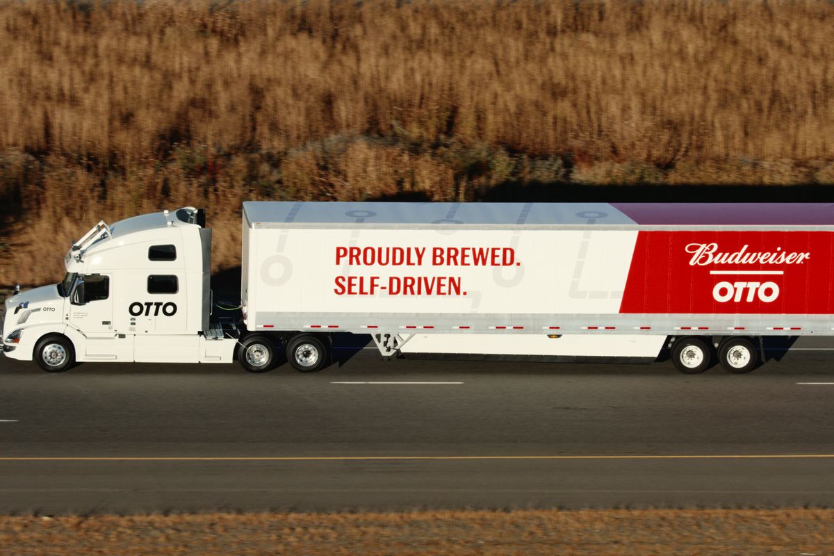 An 18-wheel truck driving down a highway reads, “Otto” and “Proudly brewed. Proudly self-driven.”