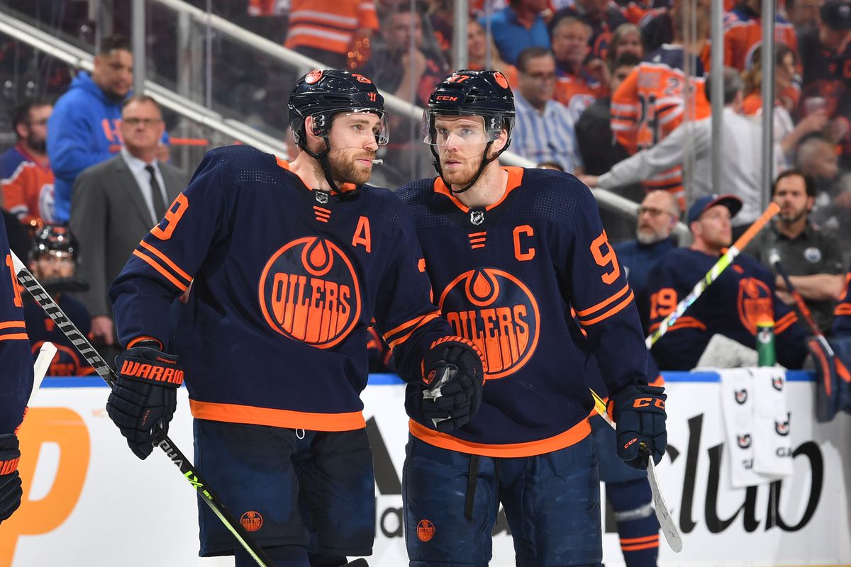 Connor McDavid #97 and Leon Draisaitl #29 of the Edmonton Oilers discuss the play during Game Seven of the First Round of the 2022 Stanley Cup Playoffs against the Los Angeles Kings on May 14, 2022 at Rogers Place in Edmonton, Alberta, Canada.