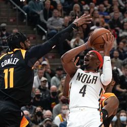 New Orleans Pelicans guard Devonte’ Graham (4) shoots as Utah Jazz guard Mike Conley (11) reaches for a block during an NBA game at Vivint Arena in Salt Lake City on Saturday, Nov. 27, 2021.