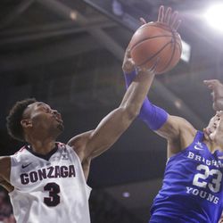 Gonzaga forward Johnathan Williams (3) and BYU forward Yoeli Childs (23) go after a rebound during the second half of an NCAA college basketball game in Spokane, Wash., Saturday, Feb. 3, 2018. Gonzaga won 68-60. (AP Photo/Young Kwak)