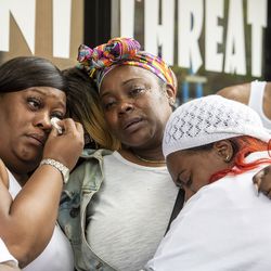 The mothers of dancers at Ultimate Threat Dance Organization comfort each other during a press conference at the studio, Thursday, May 20, 2021. Verndell Smith, the founder of the dance studio was shot and killed yesterday.