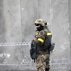 A Ukrainian government soldier stands guard in the town of Debaltseve, Ukraine, Friday, Feb. 6, 2015. German Chancellor Angela Merkel and French President Francois Holland are set to hold talks with Russian President Vladimir Putin in the Kremlin on Friday, one day after discussing peace proposals for Ukraine's conflict with Ukrainian President Petro Poroshenko. 