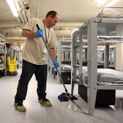 David Jarvis cleans the single men's dorm at the Road Home in Salt Lake City on Friday, Aug. 4, 2017.