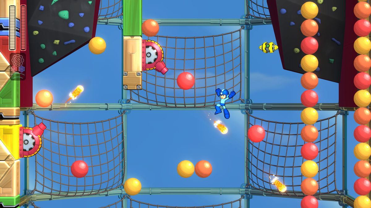Mega Man 11 - Mega Man bounces off a ball to avoid cannon fire in Bounce Man’s stage