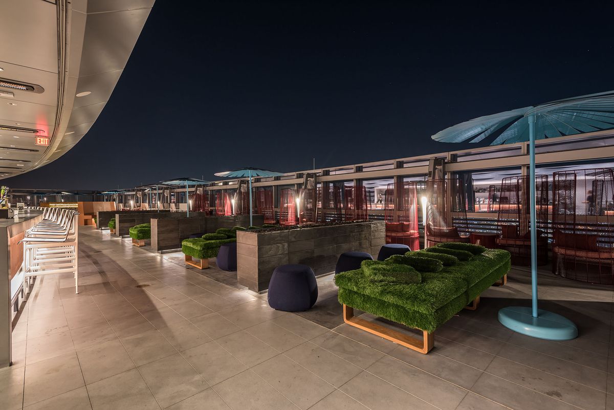 A mega-tall rooftop restaurant and bar looks out over Los Angeles at night.