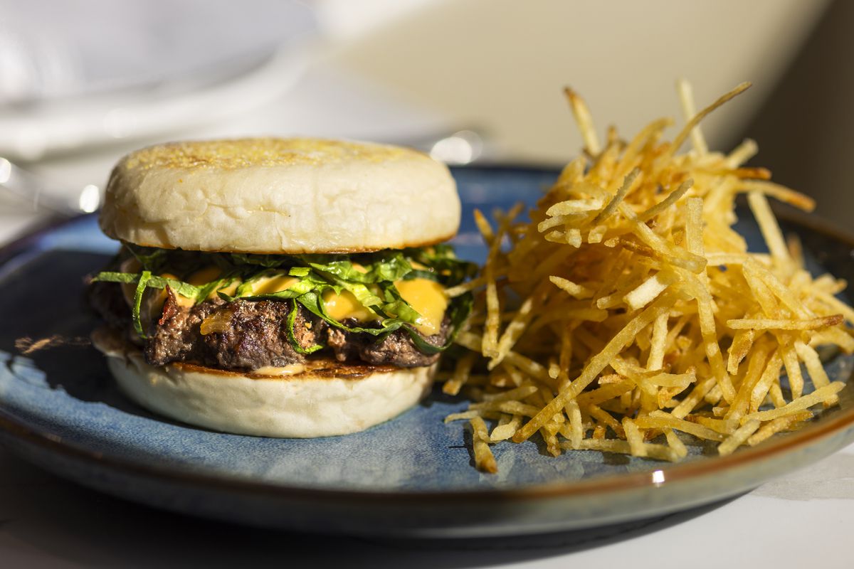 Burger with string french fries at Alice B. restaurant in Palm Springs, California.