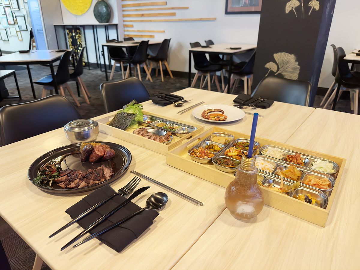 Trays of kimchee and Kalbi streak on table at Yoli