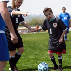 Alta's Chase Oredson kicks the ball during the 2014 Unified Soccer State High School Tournament, hosted by Special Olympics Utah and the Utah High School Activities Association, at Hillcrest High School in Midvale on Saturday, May 3, 2014.