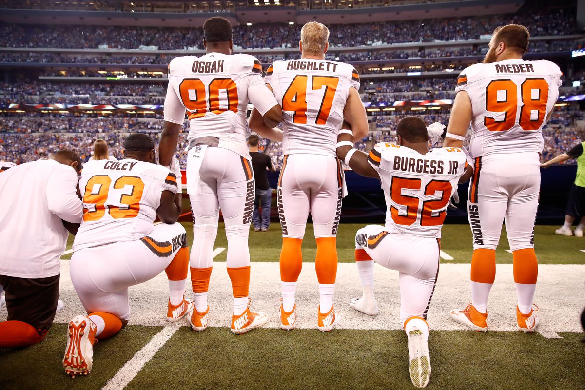 INDIANAPOLIS, IN - SEPTEMBER 24: Members of the Cleveland Browns stand and kneel during the national anthem before the game against the Indianapolis Colts at Lucas Oil Stadium on September 24, 2017 in Indianapolis, Indiana.