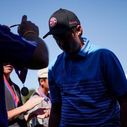 Braden Roberts, of Beaver, collects his first-place medal at the 2A high school boys golf state tournament at Rose Park Golf Course in Salt Lake City on Thursday, Sept. 26, 2019.