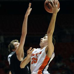 Timpview's Gavin Baxter (25) goes to the basket as Highland's Henry Morris (5) defends during the 4A state tournament at the Jon M. Huntsman Center on Monday, March 3, 2014.