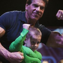 Xander Zufelt, center, shows off his muscles with Lou Ferrigno during the Salt Lake Comic Con kick off press conference at the Salt Palace Convention Center, Thursday, Sept. 4, 2014.
