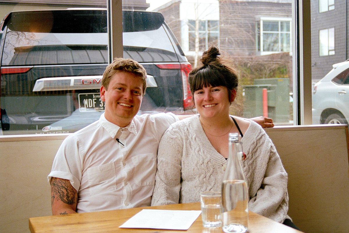 Cafe Olli owners Taylor Manning and Siobhan Speirits sit in a booth at the restaurant.