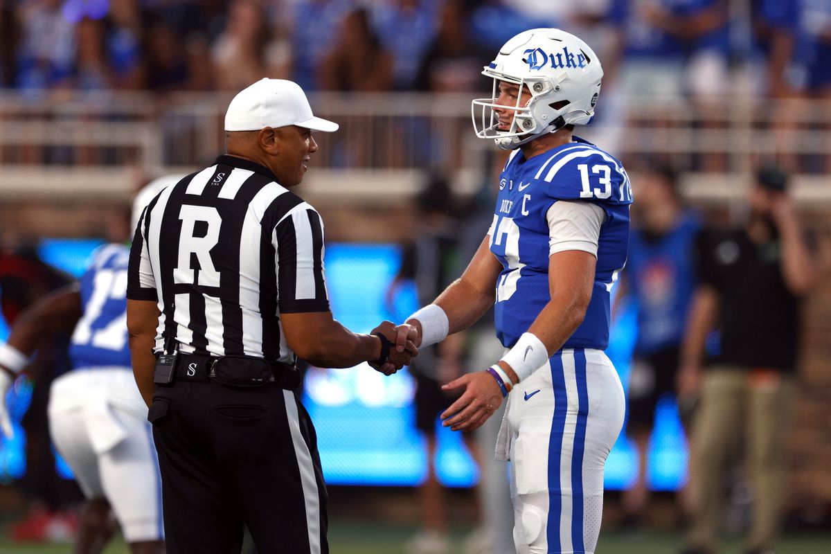 Riley Leonard of the Duke Blue Devils talks with referee Marcus Woods prior to the game against the Clemson Tigers at Wallace Wade Stadium on September 4, 2023 in Durham, North Carolina.