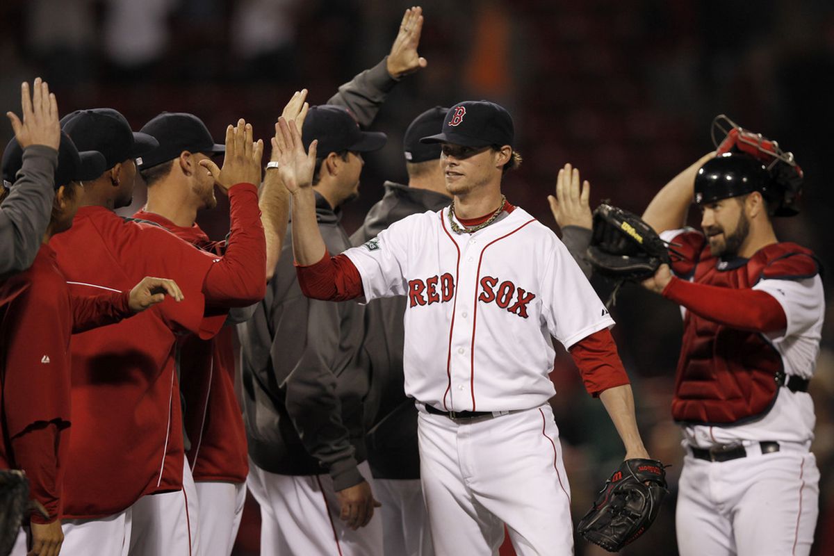 BOSTON, MA - JUNE 7:  Clay Buchholz #11 of the Boston Red Sox is congratulated by teammates after their 7-0 win over the Baltimore Orioles in the game at Fenway Park on June 7, 2012 in Boston, Massachusetts.  (Photo by Winslow Townson/Getty Images)