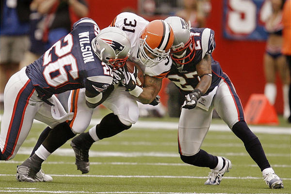 Cleveland Browns running back Jamal Lewis is tackled by the New England Patriots' Eugene Wilson (26) and Ellis Hobbs (27) before leaving the game due to injury after only one carry for 11 yards. 
