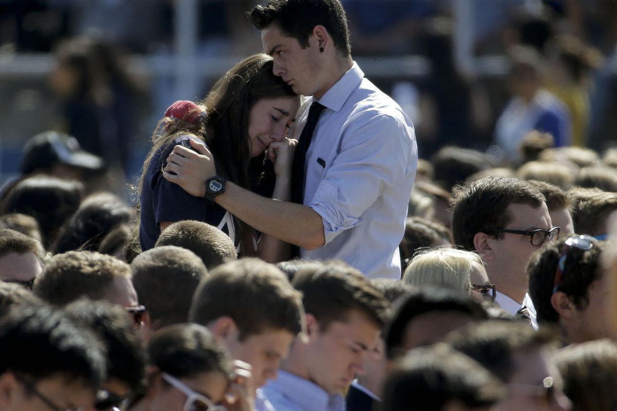 A couple embrace before a memorial service for the victims and families of Friday's rampage at Harder Stadium on the campus of University of California, Santa Barbara on Tuesday, May 27, 2014 in the Isla Vista area near Goleta, Calif. Sheriff's officials 