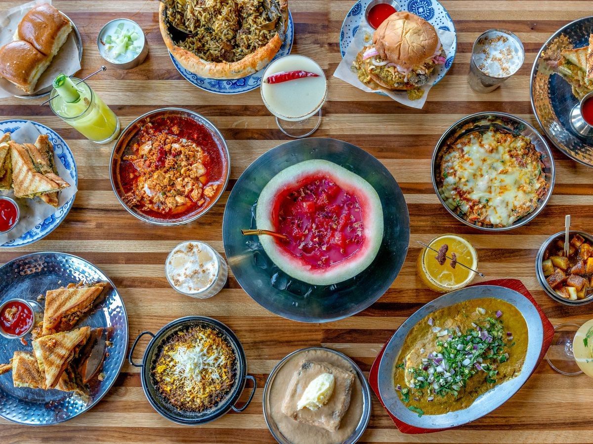 An overhead photograph of a busy table with brunch dishes.