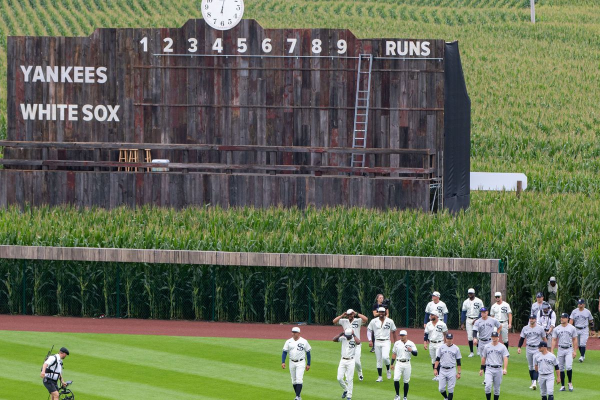 Players enter the field thought the corn before a game between the New York Yankees and the Chicago White Sox near the Field of Dreams movie site outside of Dyersville, Thursday, Aug. 12, 2021. ONE - 1n5a9049 Cr2