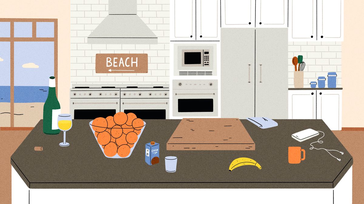 在豪华的厨房里，一个大花岗岩岛台上放着一瓶和一杯白葡萄酒，一大碗橙子，一块切菜板和其他个人物品。在背景中，有一个带帽的双炉上方有一个“海滩”的标志。插图。