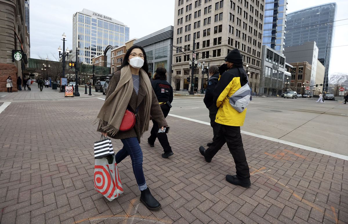 Eunjin Lee wears a mask while walking through downtown Salt Lake City on Friday, Jan. 7, 2022. A mask mandate goes into effect for Salt Lake County on Jan. 8 in response to a surge in omicron COVID-19 cases.