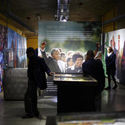 Tourists visit  a temporary exhibit on Nelson Mandela at the Apartheid Museum in Johannesburg Tuesday June 11, 2013. Former South African President Nelson Mandela is spending a fourth day in a hospital, where he is being treated for a recurring lung infection. 