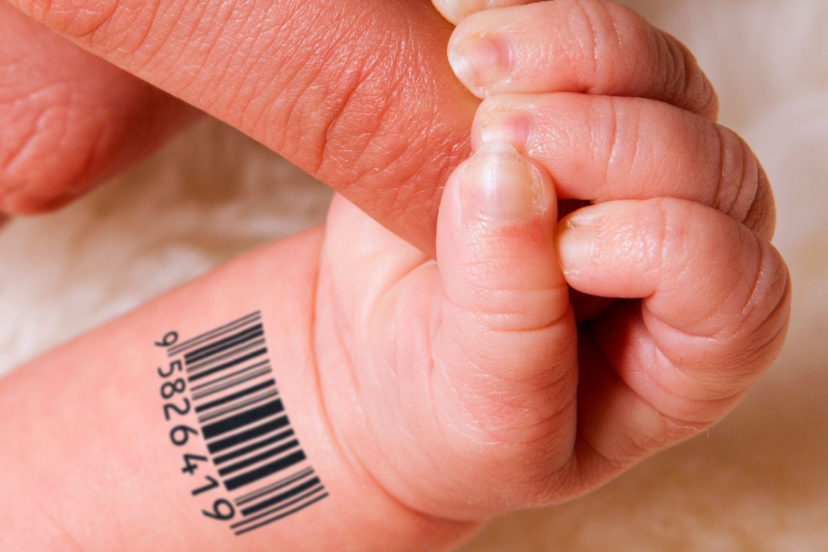 A baby’s hand sporting a UPC barcode on its wrist holds onto an adult’s finger.