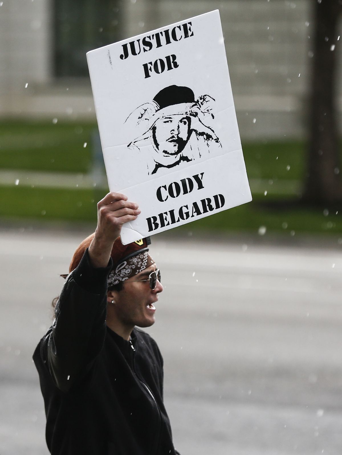A protesters demonstrates outside the Salt Lake County District Attorney’s Office in Salt Lake City on Friday, May 24, 2019. The protesters laid on the grass in tarps with toe tags of individuals killed by police.