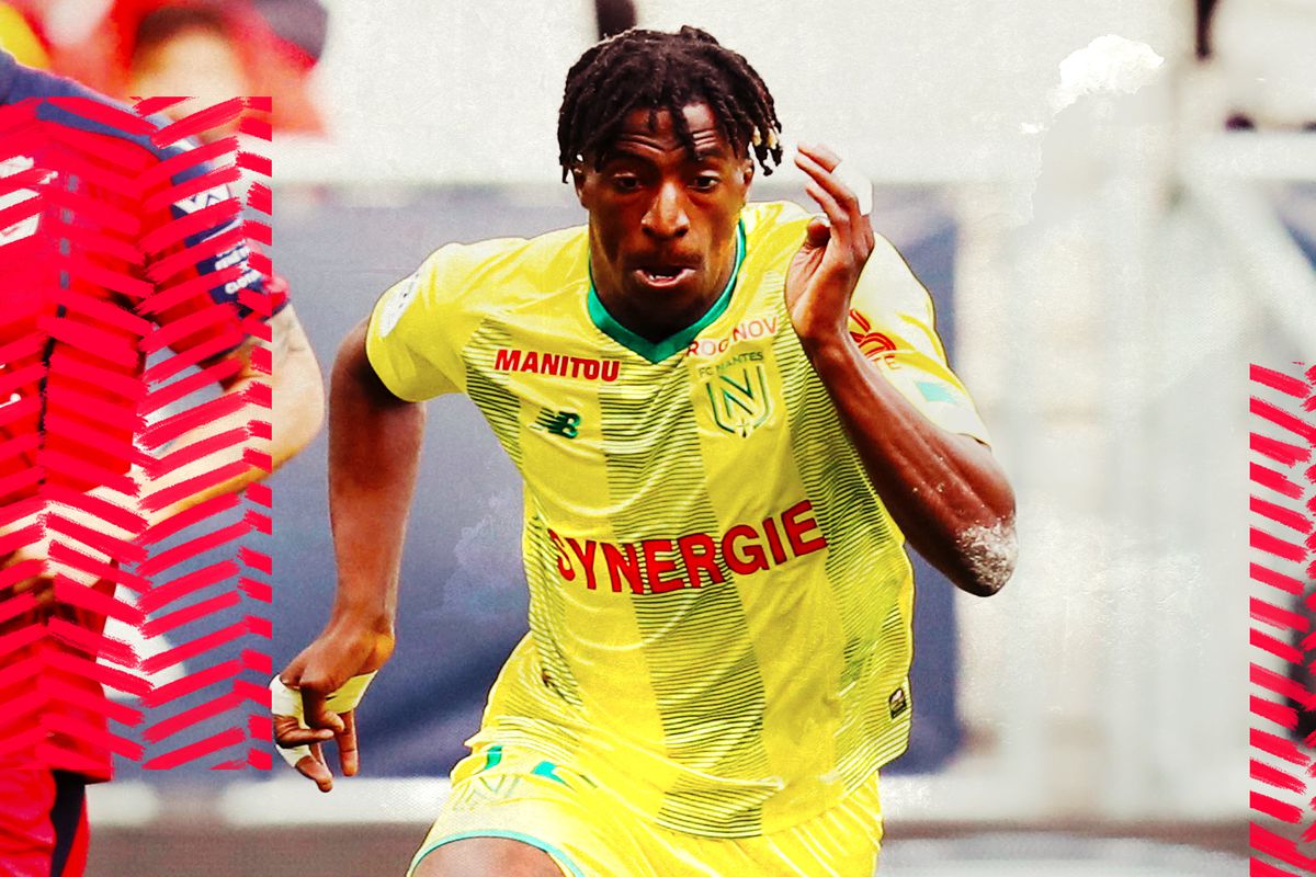 Kader Mamba in a yellow FC Nantes jersey sprinting towards the camera.