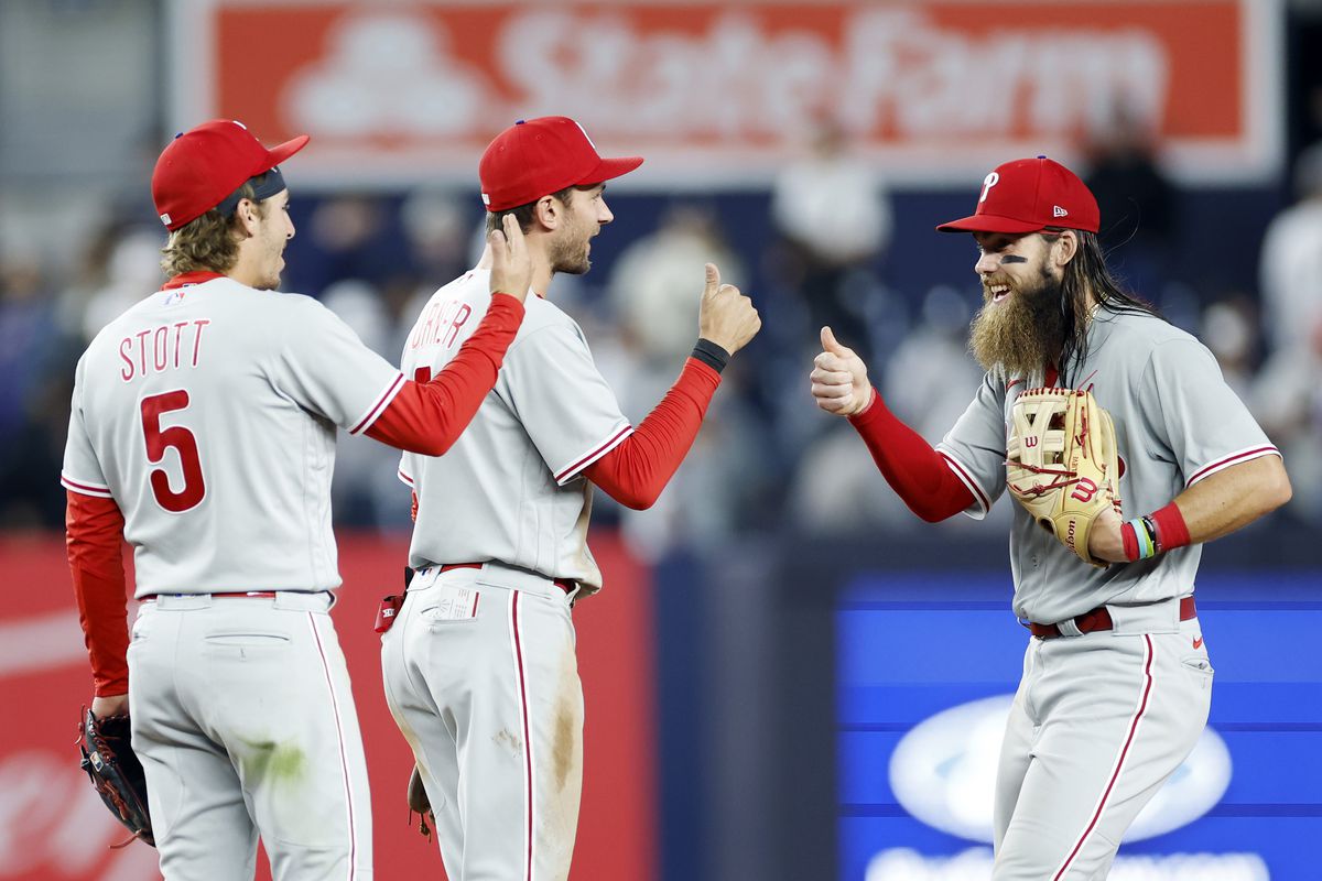 Brandon Marsh celebrates with Bryson Stott and Trea Turner of the Philadelphia Phillies after the ninth inning against the Philadelphia Phillies at Yankee Stadium on April 04, 2023 in the Bronx borough of New York City.