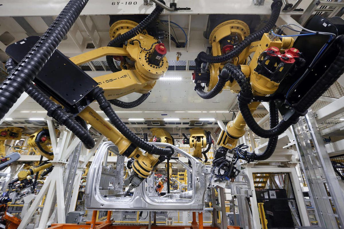 Robots install rivets on a 2015 Ford F-150 truck at the Dearborn Truck Plant in Dearborn, Mich.