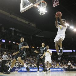 California forward Jaylen Brown (0) shoots in front of Hawaii guard Aaron Valdes (32) and guard Quincy Smith (11) during the first half of a first-round men's college basketball game in the NCAA Tournament in Spokane, Wash., Friday, March 18, 2016. (AP Photo/Young Kwak)