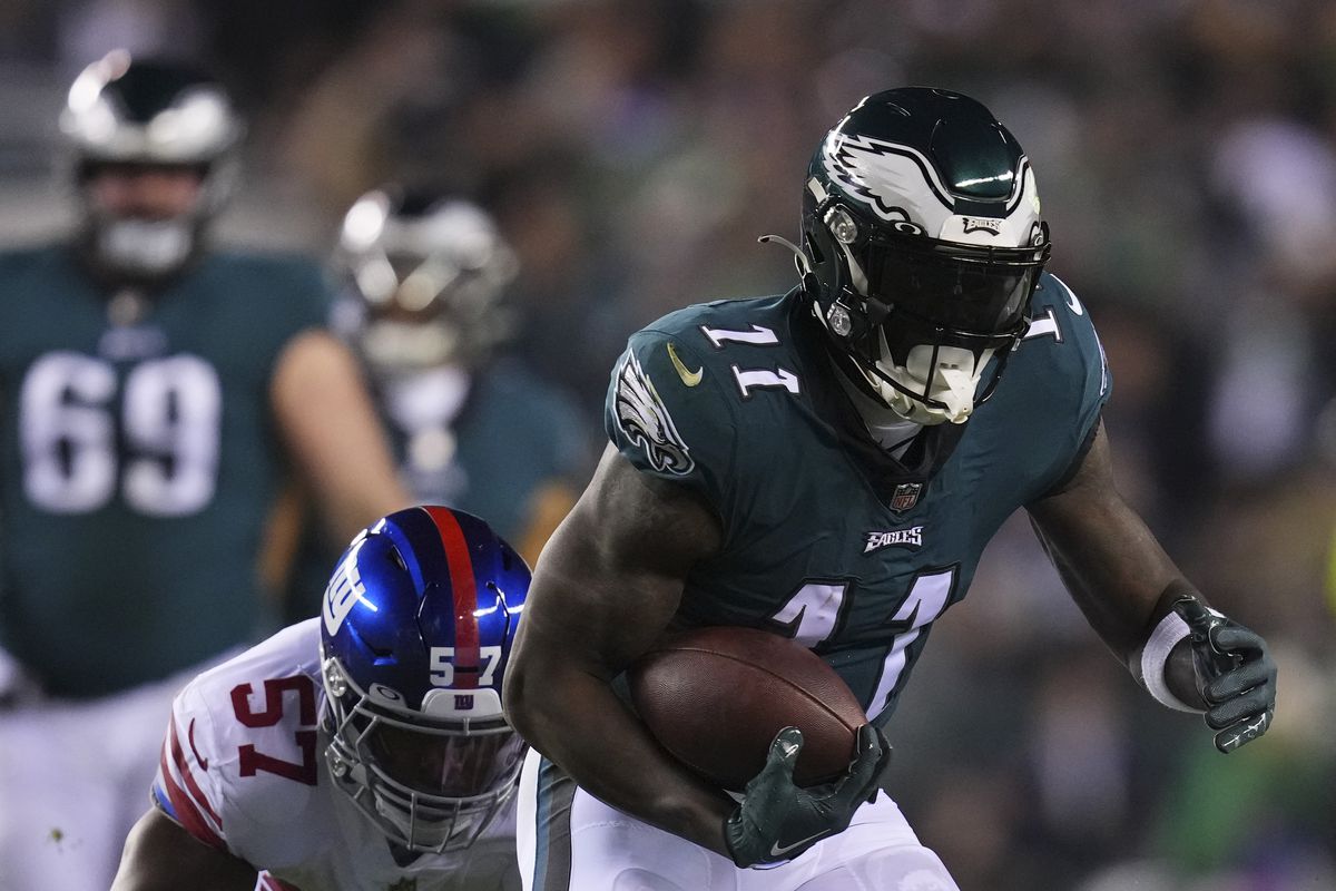 A.J. Brown of the Philadelphia Eagles runs with the ball against Jarrad Davis of the New York Giants during the NFC Divisional Playoff game at Lincoln Financial Field on January 21, 2023 in Philadelphia, Pennsylvania.