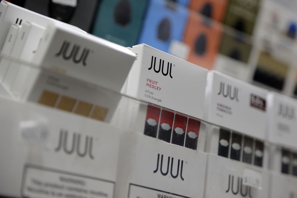 FILE - In this Dec. 20, 2018, file photo Juul products are displayed at a smoke shop in New York. Under scrutiny amid a wave of underage vaping, Juul is pushing into television with a multimillion-dollar campaign rebranding itself as a stop-smoking aid fo