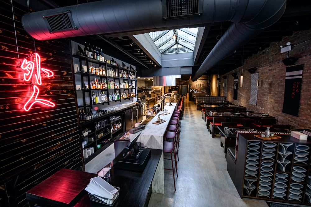 The inside of a dark-hued restaurant and bar.
