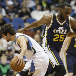 Minnesota Timberwolves' Ricky Rubio, left, assumes a low profile around Utah Jazz's Al Jefferson of Spain in the first quarter of an NBA basketball game Monday, April 15, 2013 in Minneapolis. 