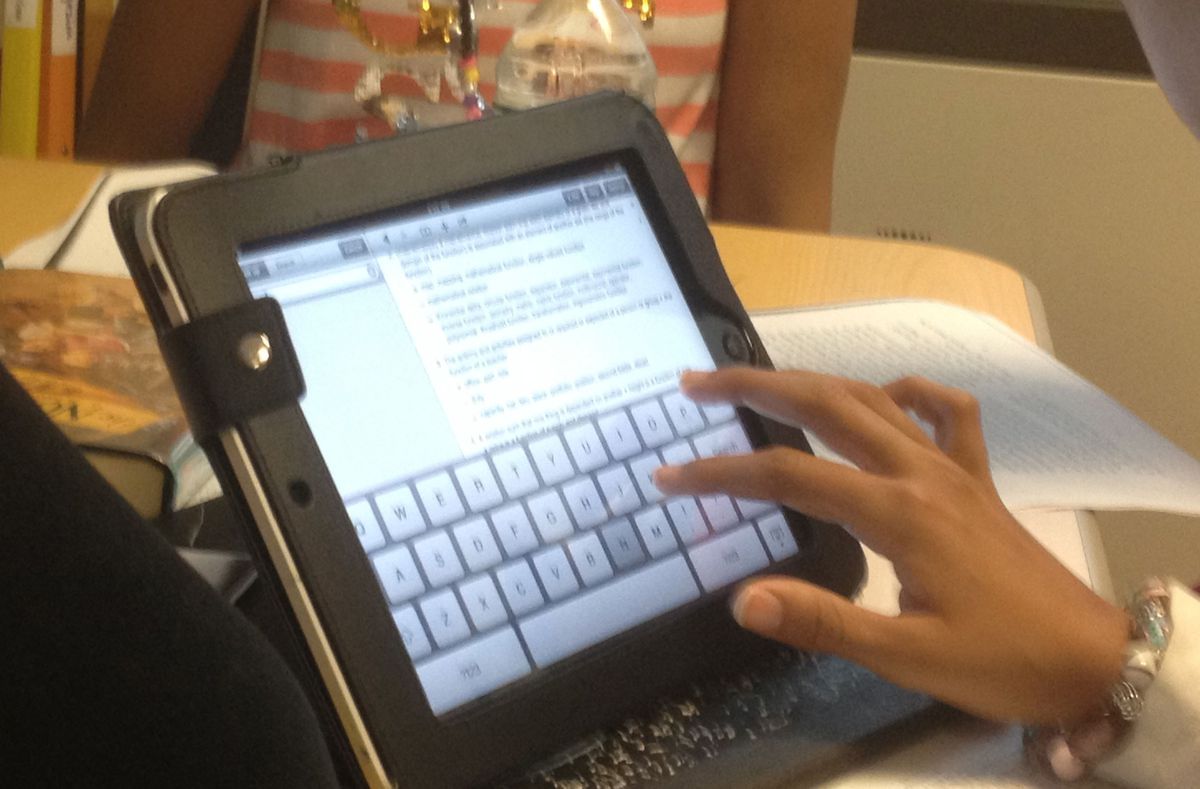 A student in Darby Masland’s sixth grade class uses an iPad to look up the definition of illustrious for her classmates during unison reading. Unison reading is a core of the method that will inform a new Clinton Hill middle school.