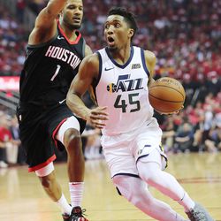Utah Jazz guard Donovan Mitchell (45) drives past Houston Rockets forward Trevor Ariza (1) as the Utah Jazz and the Houston Rockets play game two of the NBA playoffs at the Toyota Center in Houston on Wednesday, May 2, 2018.