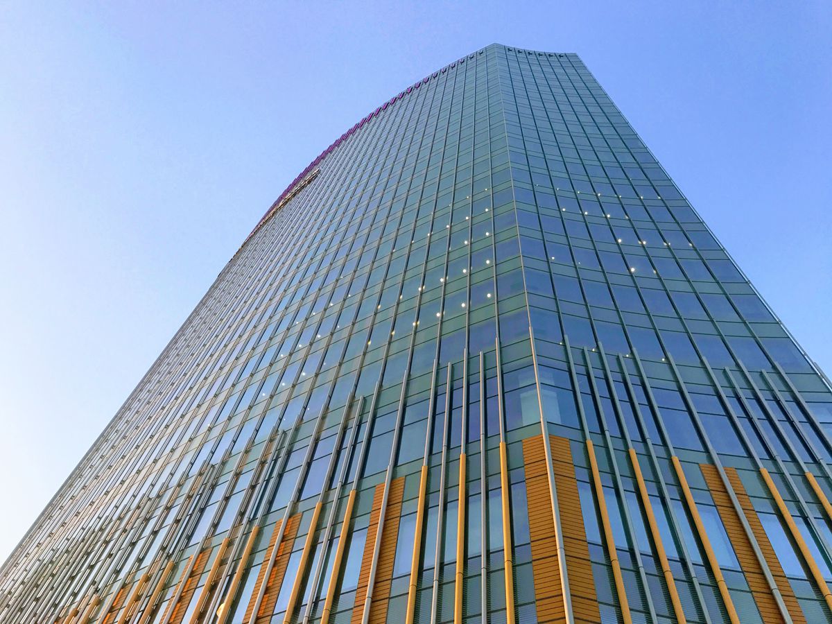 The exterior of the CHOP Tower in Philadelphia. The facade is glass with red structural details.