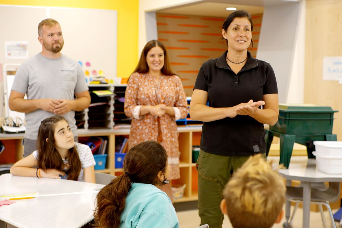 S21 E1, Jenn Nawada and Nathan Gilbert in an elementary school classroom
