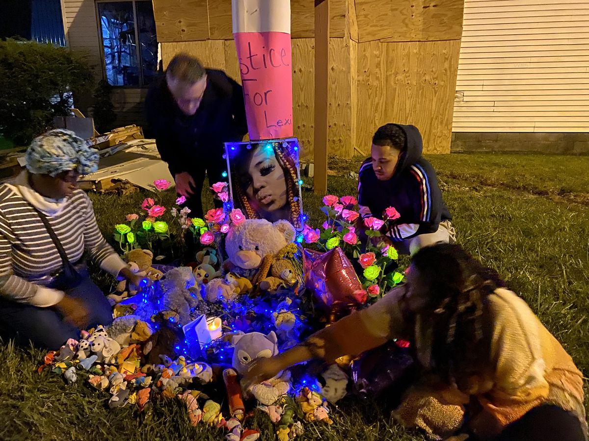 Community members gather at a memorial set up for Alexis Wilson near the site of the crash. 