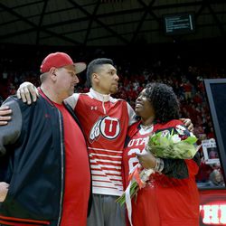 Coach Larry Krystkowiak stands with Jordan Loveridge and his family as the five seniors on the team, Brandon Taylor, Jordan Loveridge, Dakarai Tucker and Austin Eastman, along with former player and current student manager Jeremy Olsen,  were recognized before the game against the Colorado Buffaloes at the University of Utah's Huntsman Center in Salt Lake City on Saturday, March 5, 2016.  